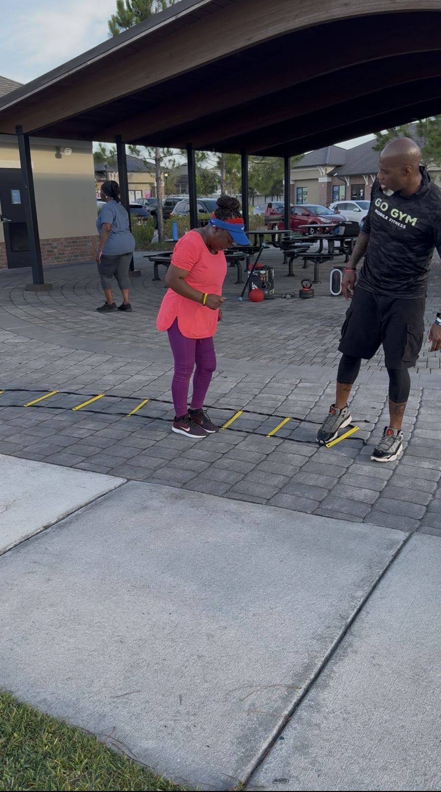 Coach Jerry guiding ladder work with a client